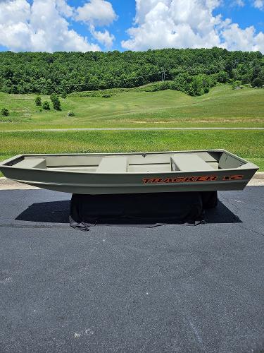 Tracker Grizzly 12 Jon 2025 Tracker Grizzly 12 Jon boat on pavement, green landscape background.