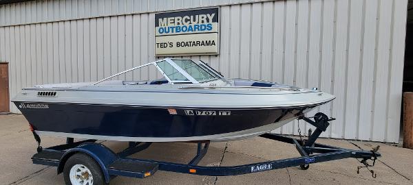 Four Winns 160 Freedom 1986 Four Winns 160 Freedom boat on trailer, parked outside Ted's Boatarama.