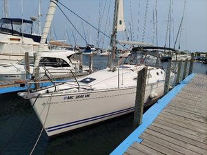Jeanneau 34.2 2000 Jeanneau 34.2 sailboat docked at marina, side view.