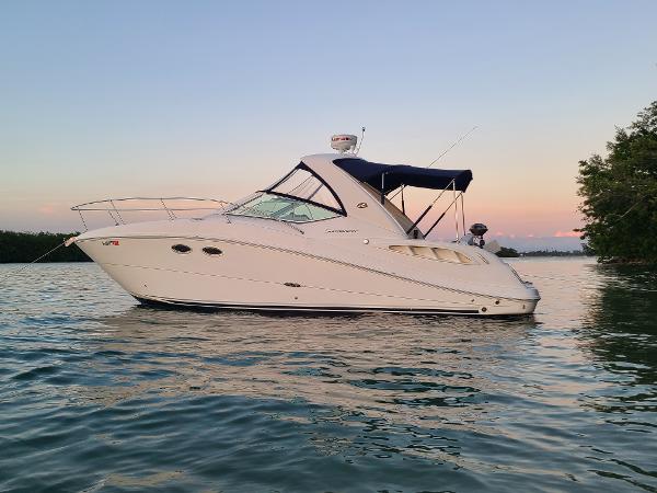 Sea Ray 290 Sundancer 2006 Sea Ray 290 Sundancer boat on calm water at sunset.