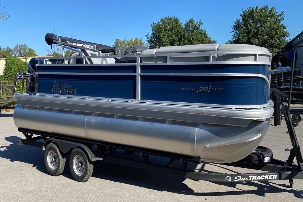 Sun Tracker SportFish 20 DLX 2026 Sun Tracker SportFish 20 DLX pontoon boat on trailer, blue and silver design.