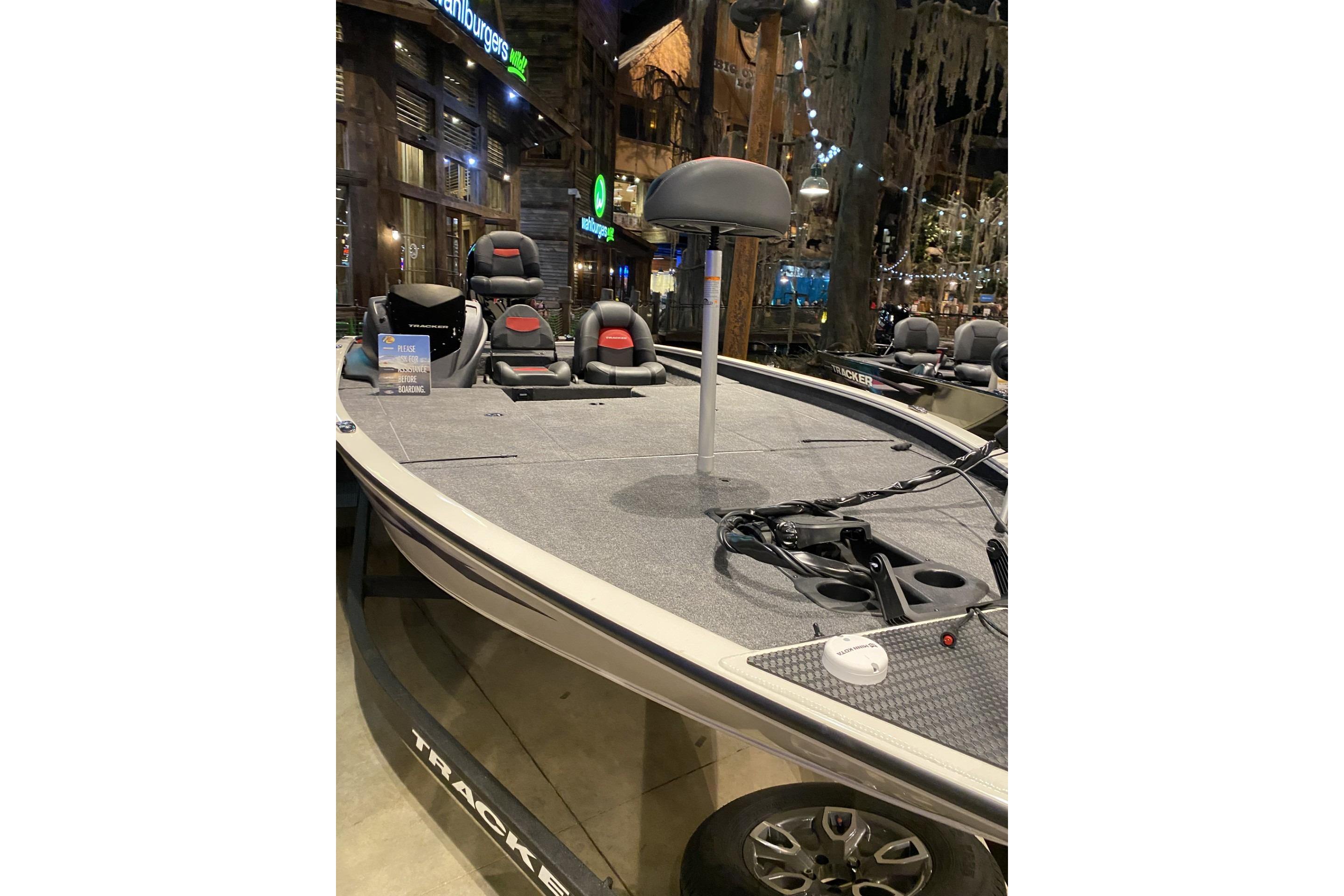 Tracker Savage 215 2025 Tracker Savage 215 boat displayed indoors with seating and fishing equipment.