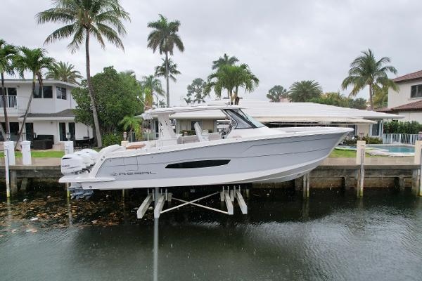Regal 38 SAV 2021 Regal 38 SAV boat docked near waterfront homes with palm trees.