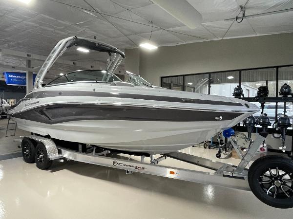 Crownline Eclipse E260 XS 2024 Crownline Eclipse E260 XS boat on a trailer in a showroom.