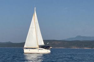 Elan Impression 434 Sailing yacht Elan Impression 434, 2005 model, gliding on calm sea with distant hills.