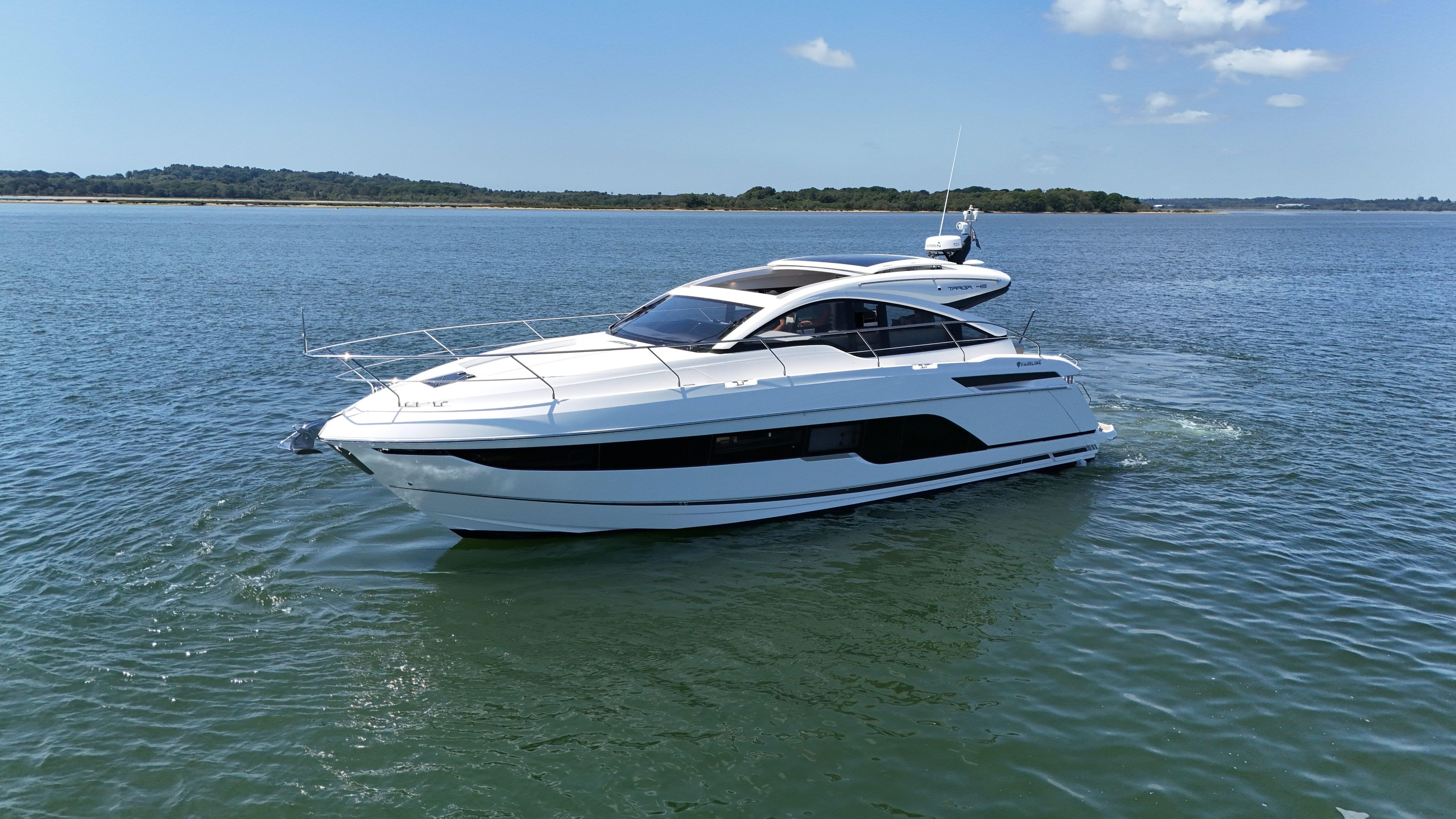 Fairline Targa 45 GT 2021 Fairline Targa 45 GT yacht cruising on calm waters under a clear sky.