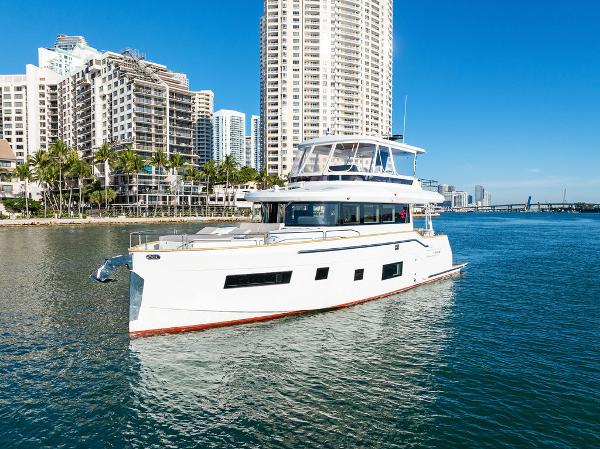 Sirena 58 2022 Sirena 58 yacht cruising near urban waterfront with skyscrapers.