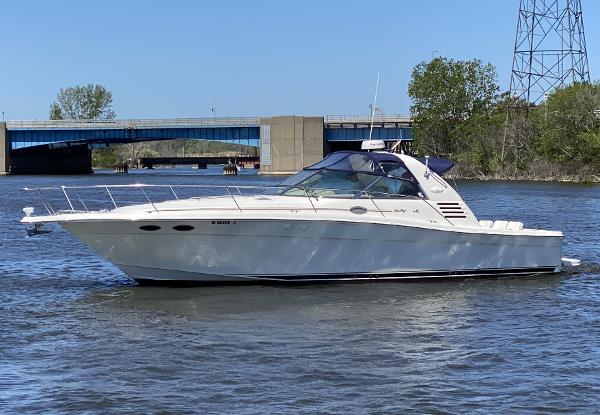 Sea Ray 370 Express Cruiser 1999 Sea Ray 370 Express Cruiser on a river near a bridge and trees.