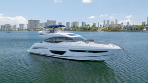 Princess S65 Luxurious 2017 Princess S65 yacht anchored in a scenic urban waterfront.