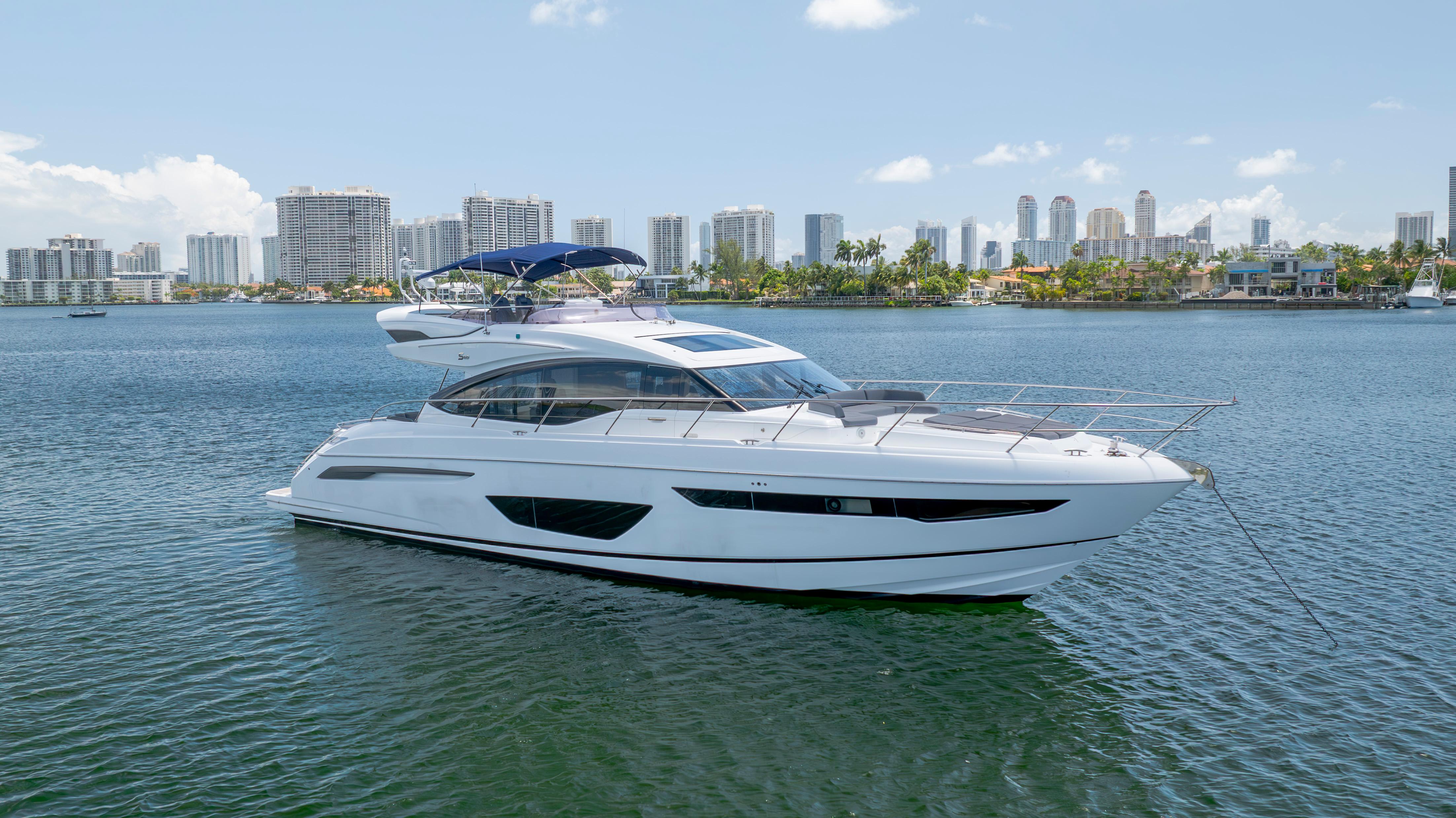 Princess S65 Luxurious 2017 Princess S65 yacht anchored in a scenic urban waterfront.