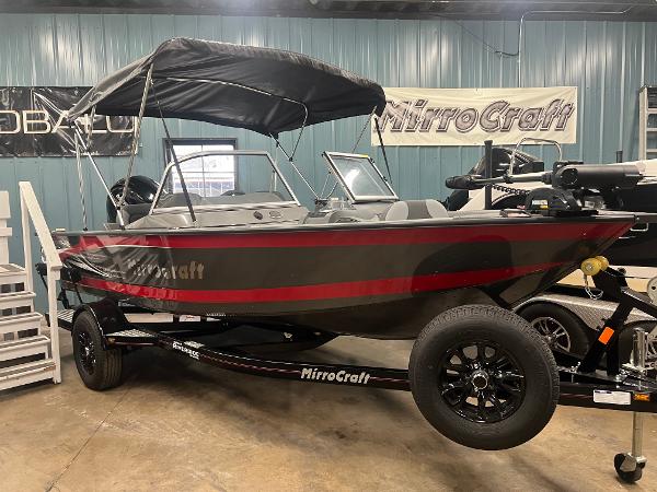 MirroCraft 176 Dual Impact 2023 MirroCraft 176 Dual Impact boat with canopy in showroom.