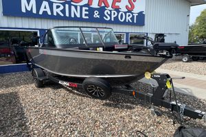 Alumacraft Trophy 185X Sport 2025 Alumacraft Trophy 185X Sport boat on trailer outside marine store.