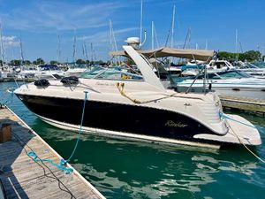 Rinker Fiesta Vee 300 2006 Rinker Fiesta Vee 300 boat docked in a marina under a clear blue sky.