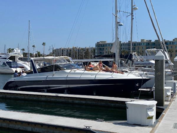 Silverton 38 Express 1993 Silverton 38 Express yacht docked at marina with people sunbathing.