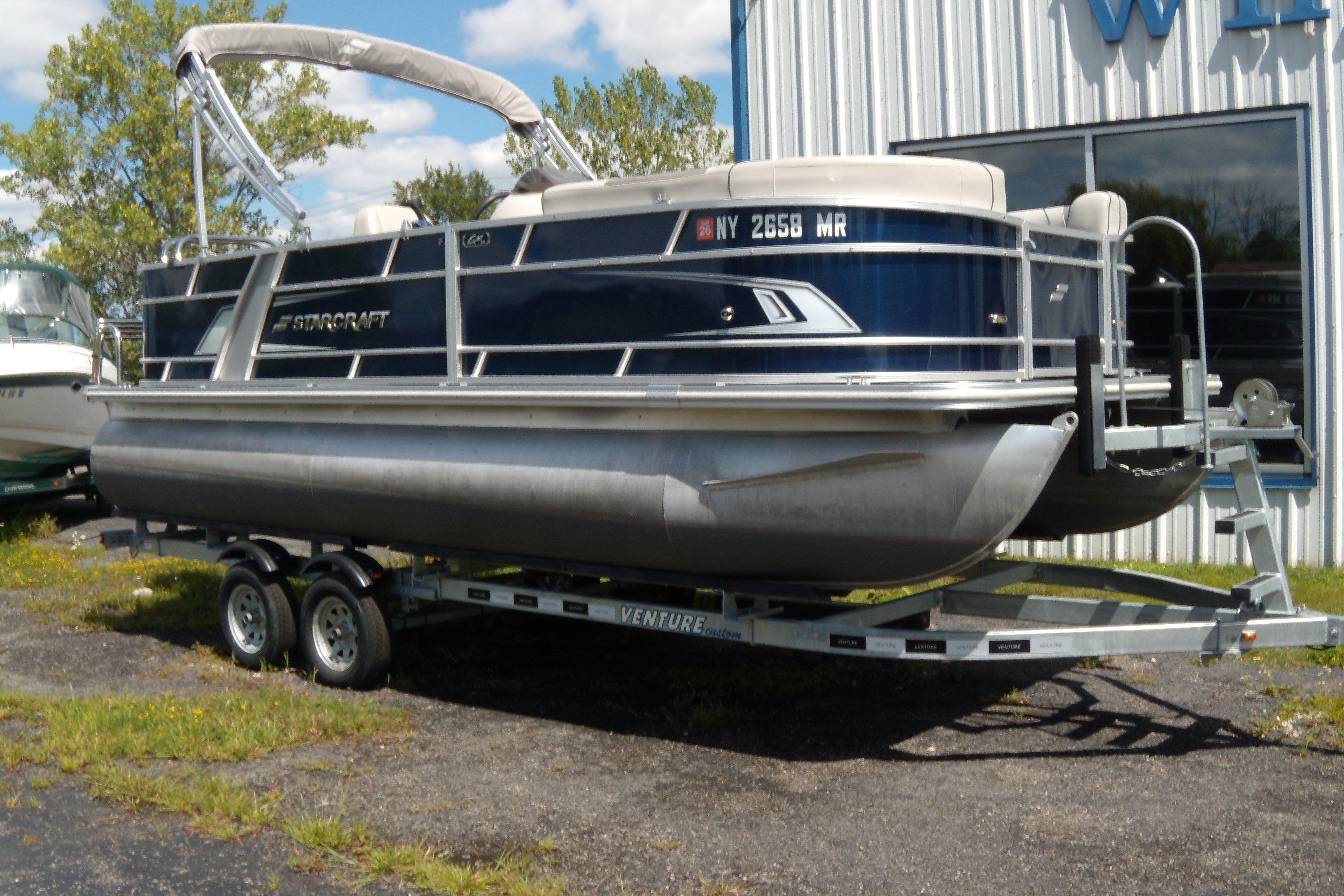 Starcraft EX 20 C 2020 Starcraft EX 20 C pontoon boat on trailer, parked outdoors.