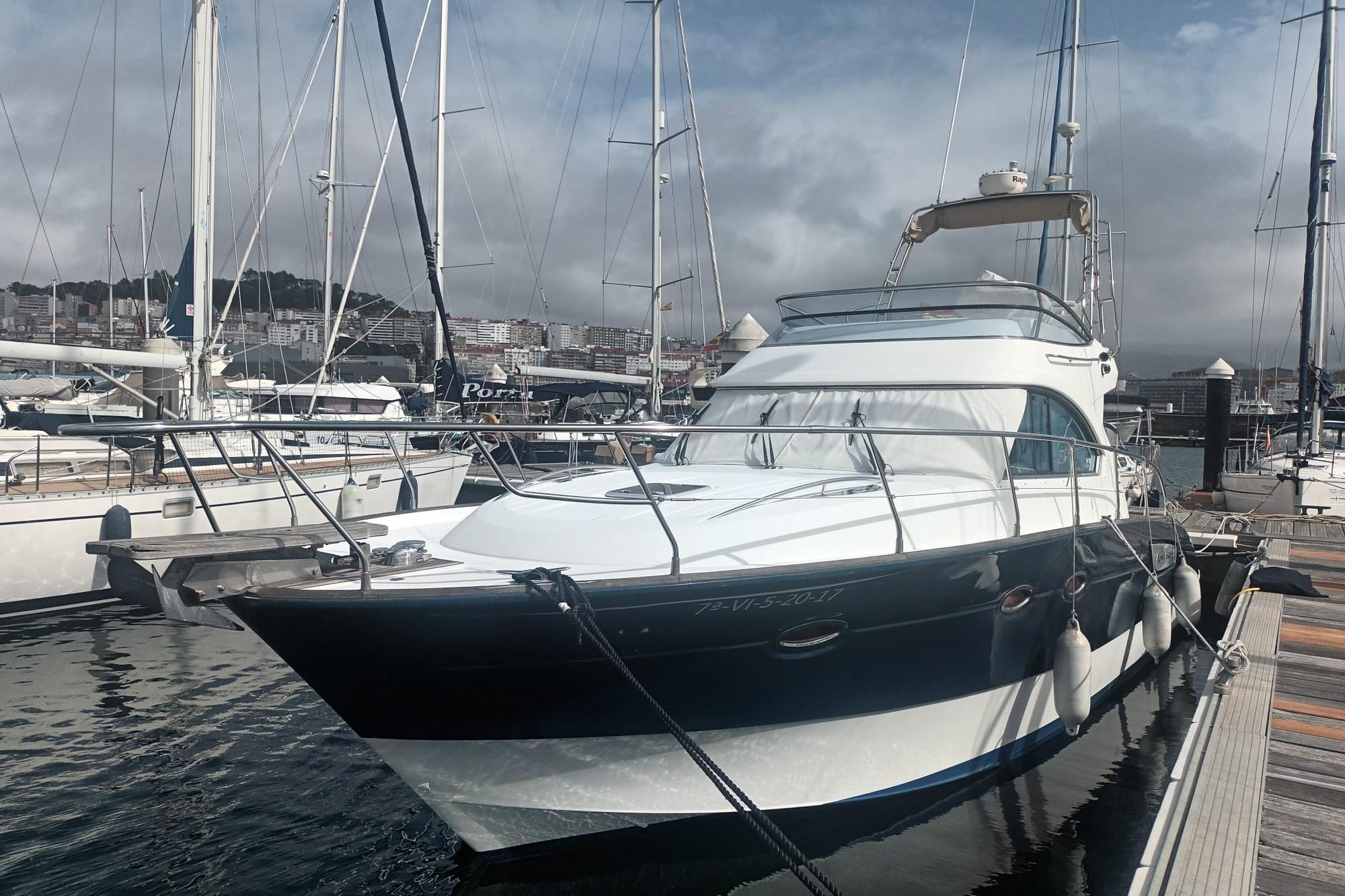 Beneteau Antares 12 2008 Beneteau Antares 12 Fly Sport yacht docked in marina, surrounded by sailboats.