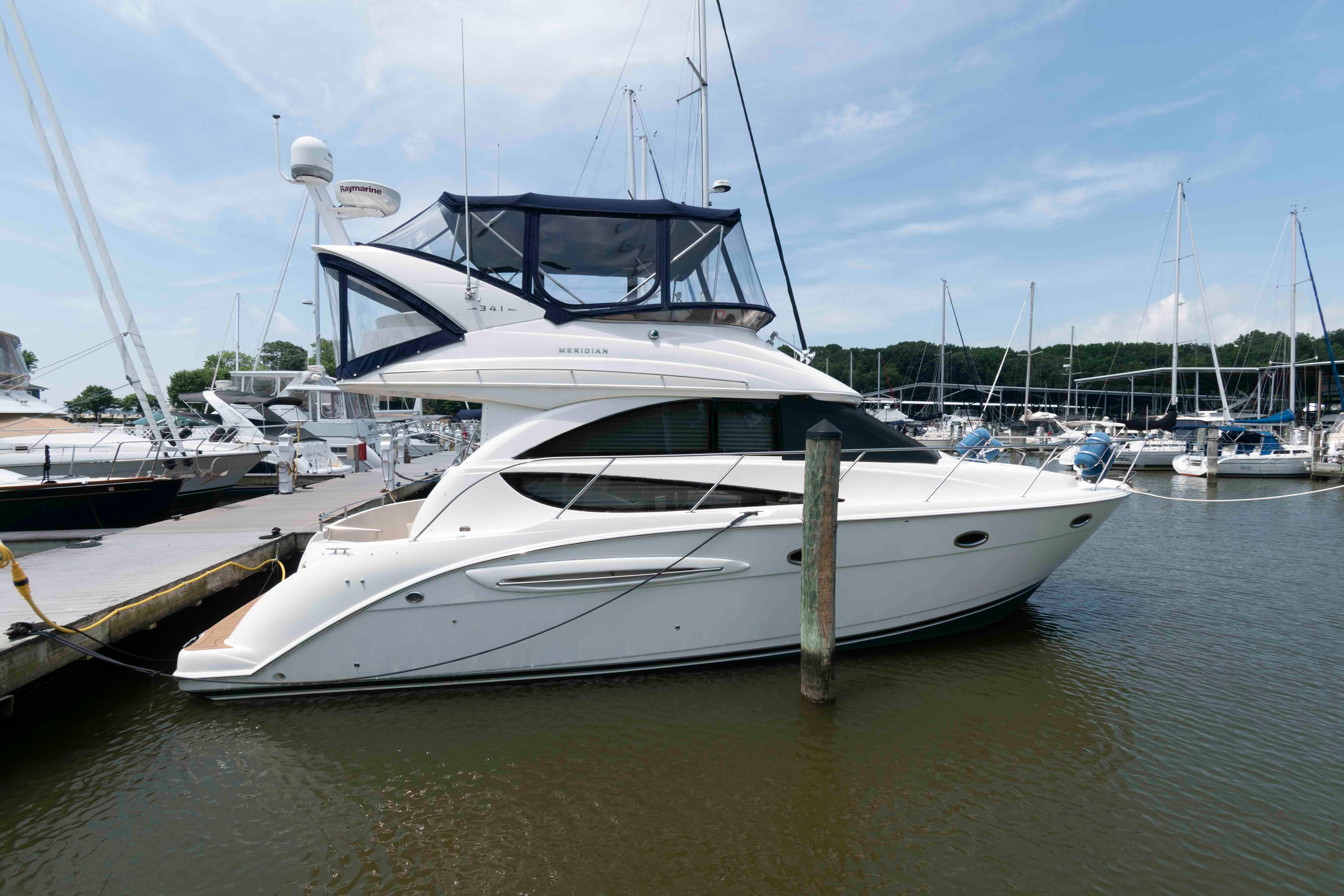 Meridian 341 Sedan 2006 Meridian 341 Sedan yacht docked at marina, surrounded by other boats.