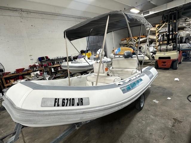 Novurania DL 400 1996 Novurania DL 400 inflatable boat with canopy in a workshop setting.