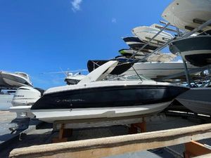 Regal 26 OBX 2021 Regal 260BX boat displayed in a marina under a clear blue sky.