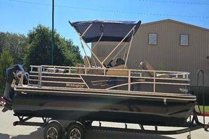 Ranger Reata 223F 2025 Ranger Reata 223F pontoon boat on trailer, parked outdoors.