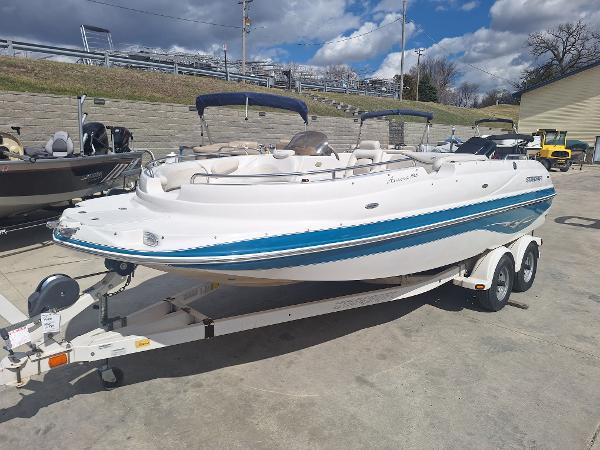 Starcraft Aurora 1915 OB 2004 Starcraft Aurora 1915 OB boat on trailer, white with blue accents, parked outdoors.