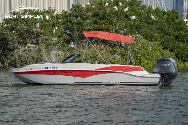 Starcraft SVX 210 OB DC 2024 Starcraft SVX 210 OB DC boat with red canopy on water.