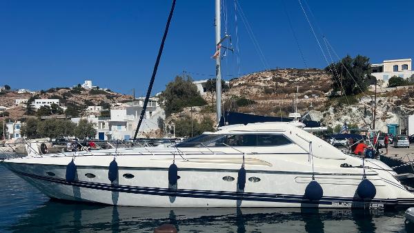 Sunseeker Predator 63 1996 Sunseeker Predator 63 yacht docked in a scenic coastal marina.