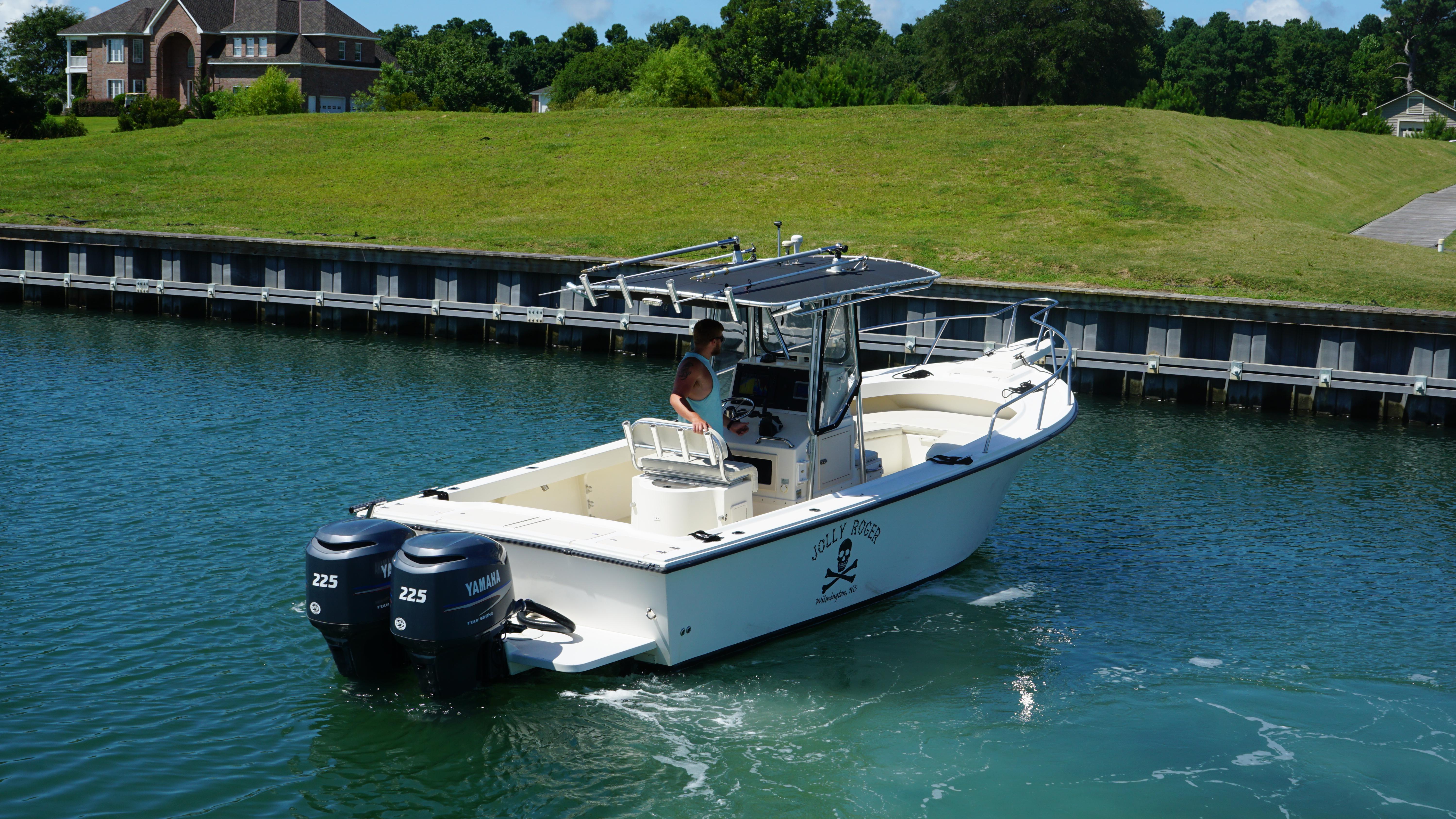 Parker 2501 Center Console 2005 Parker 2501 Center Console boat with dual Yamaha engines on a calm waterway.