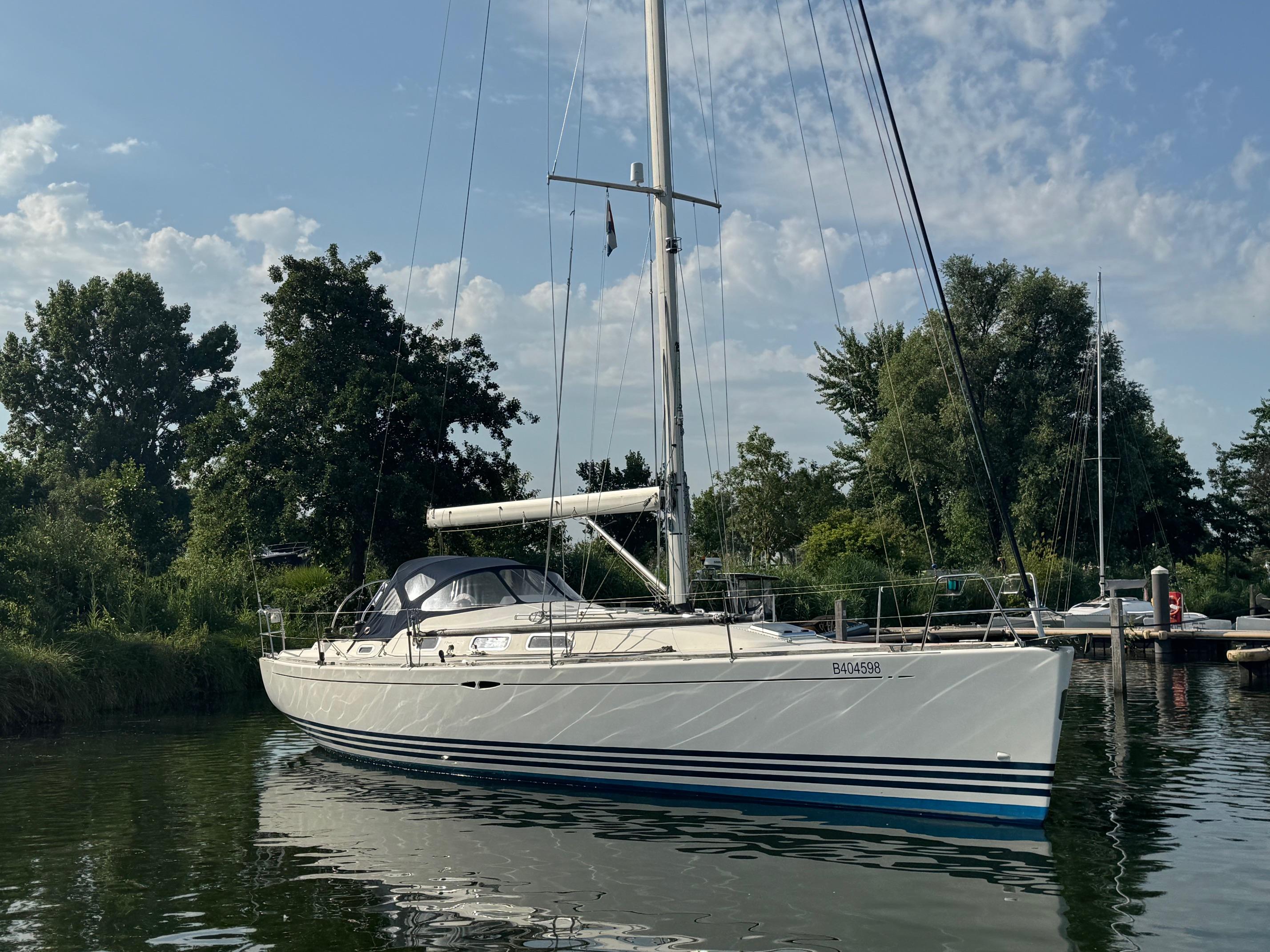 X-Yachts X-40 2008 X-Yachts X-40 sailboat docked on a calm waterway with lush greenery.
