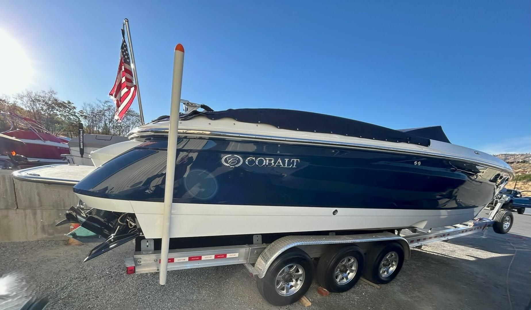 Cobalt 343 2005 Cobalt 343 boat on trailer with American flag in background.