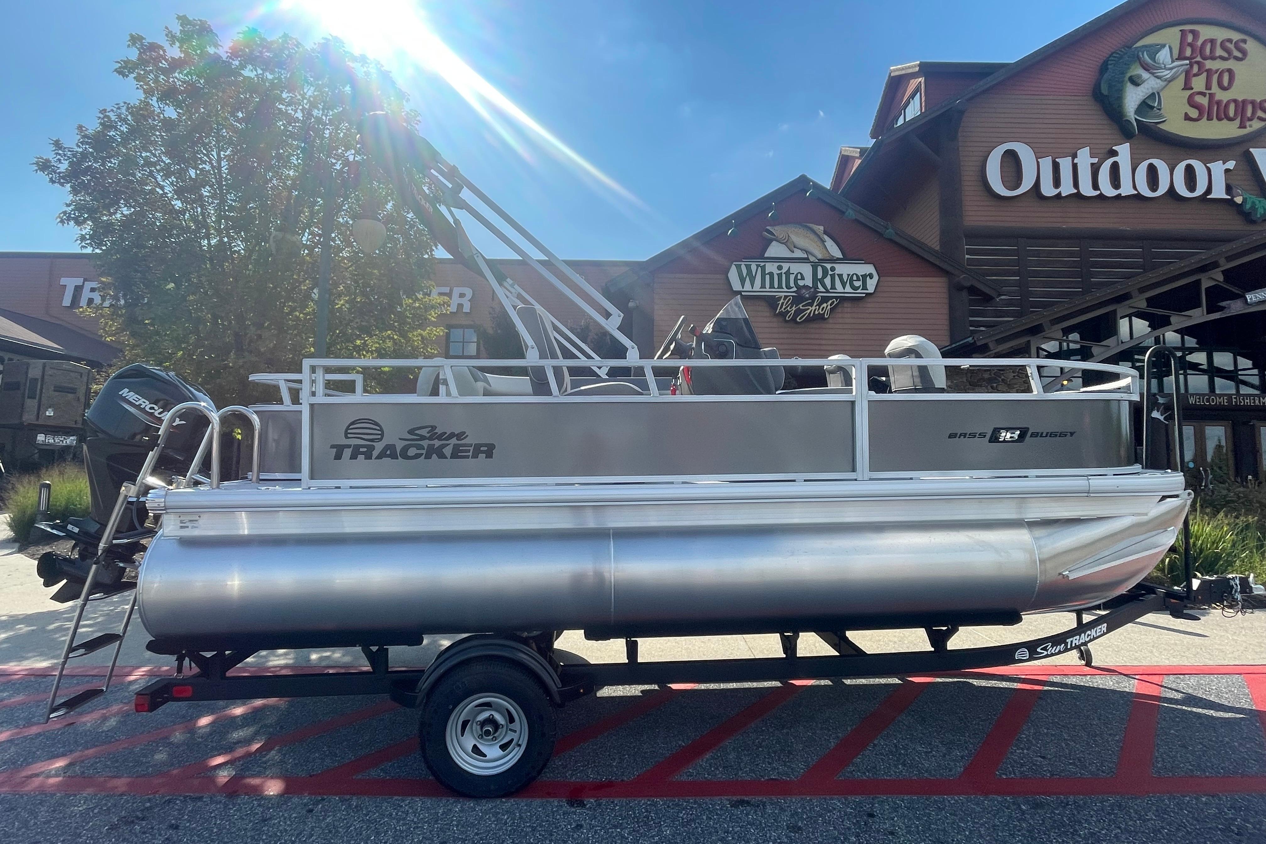 Sun Tracker Bass Buggy 18 DLX 2026 Sun Tracker Bass Buggy 18 DLX pontoon boat outside Bass Pro Shops.