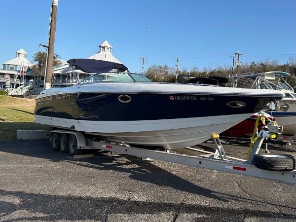 Cobalt 343 2005 Cobalt 343 boat on trailer, parked outdoors, clear sky background.
