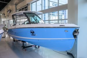 Monterey Elite 30 OB 2026 Monterey Elite 30 OB boat displayed in a showroom, featuring a sleek blue design.