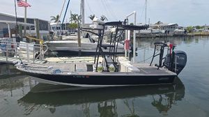Hewes Redfisher 21 2023 Hewes Redfisher 21 boat docked at a marina, calm water, clear sky.