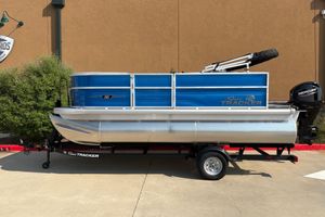 Sun Tracker Party Barge 16 DLX 2026 Sun Tracker Party Barge 16 DLX pontoon boat on trailer, side view.