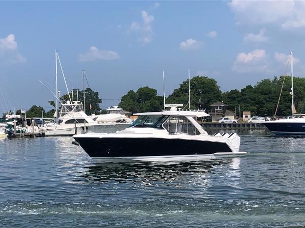 Tiara Yachts 38 LS 2024 Tiara Yachts 38 LS cruising in a marina with other boats.