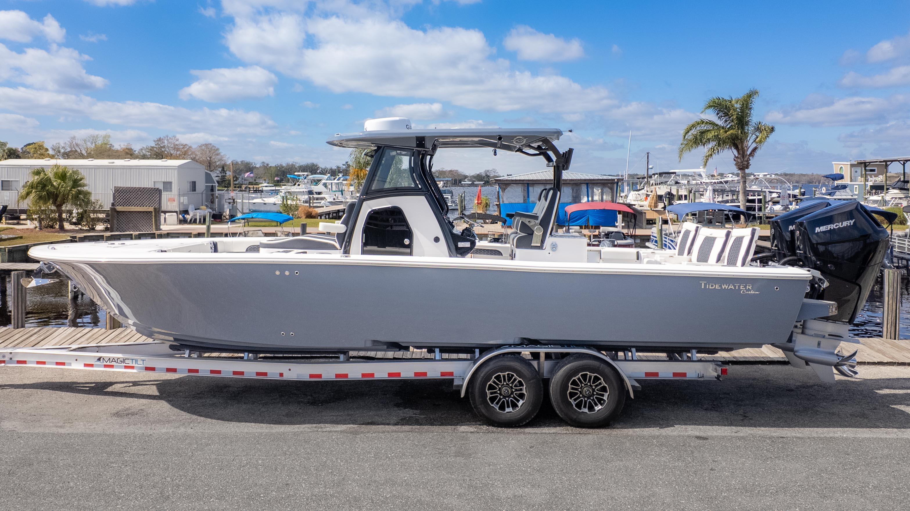 Tidewater Carolina Bay 3100 2025 Tidewater Carolina Bay 3100 boat on trailer at marina, clear sky background.