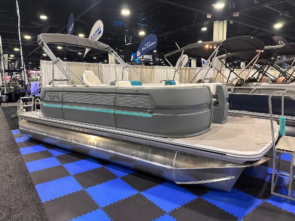 Avalon Aura 21' 2025 Avalon Aura 21' pontoon boat displayed indoors on blue checkered floor.