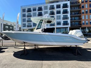 Boston Whaler 280 Dauntless 2025 Boston Whaler 280 Dauntless boat displayed outdoors near modern buildings.