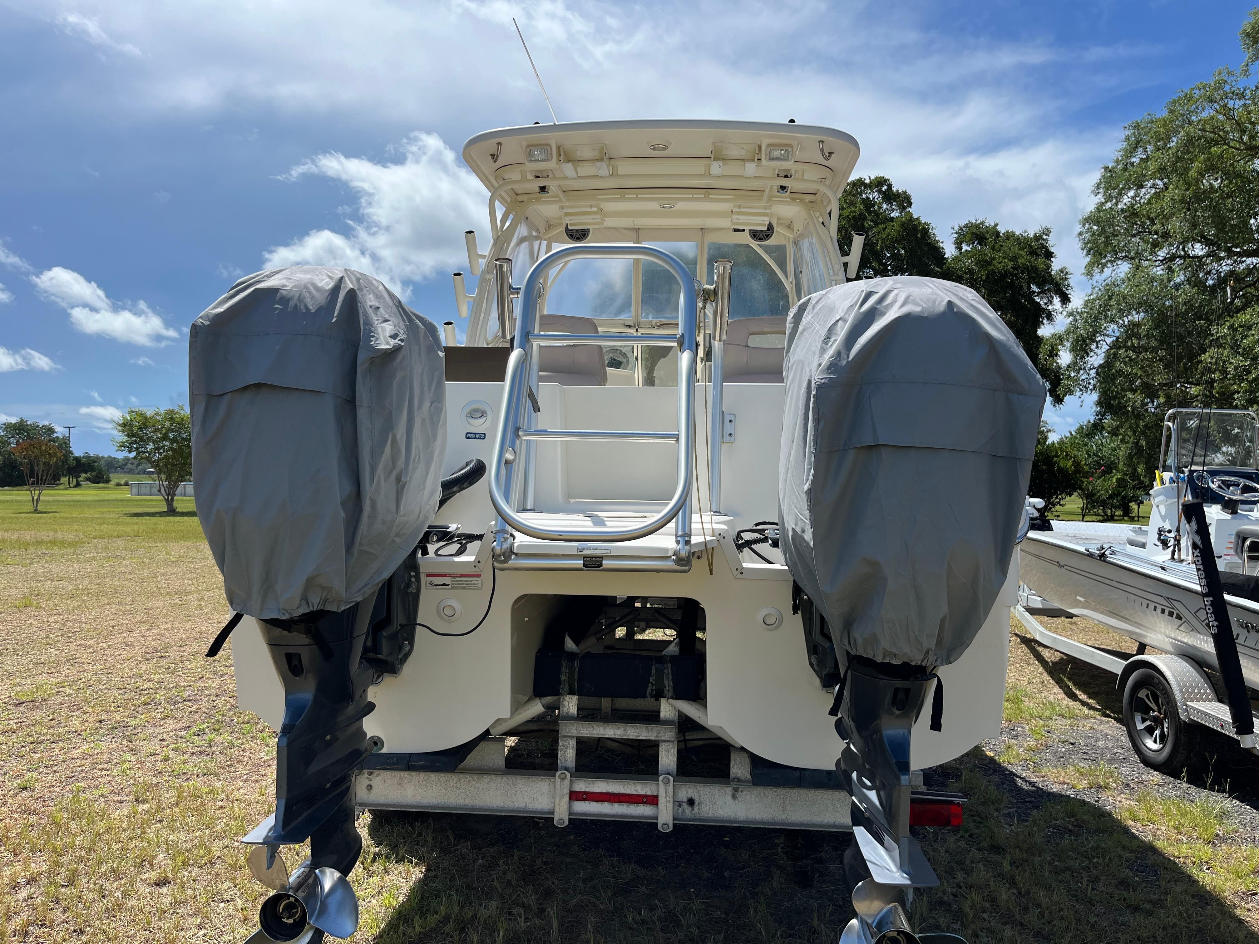 World Cat 255 DC 2017 World Cat 255 DC boat with dual covered outboard motors on a trailer.