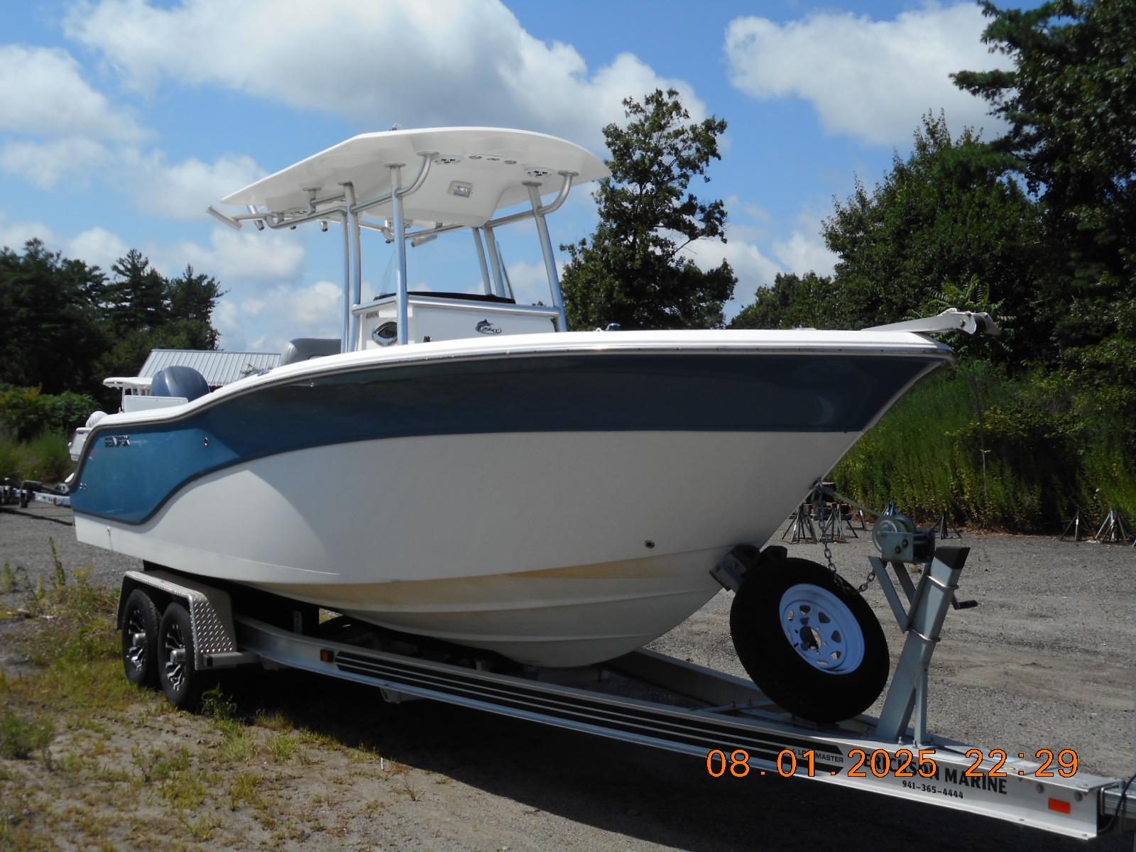 Sea Fox 256 Commander 2013 Sea Fox 256 Commander boat on trailer, parked outdoors under a blue sky.