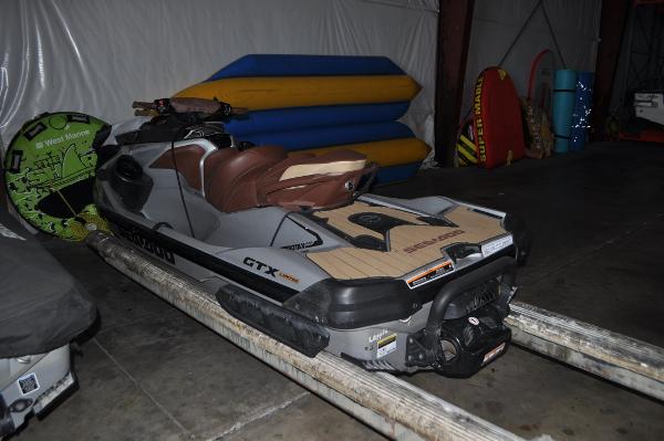 Sea-Doo GTX Limited 230 2018 Sea-Doo GTX Limited 230 jet ski in storage with water sports equipment.