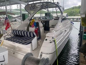 Regal Commodore 3760 IO 2006 Regal Commodore 3760 IO boat docked, featuring striped seating and American flag.