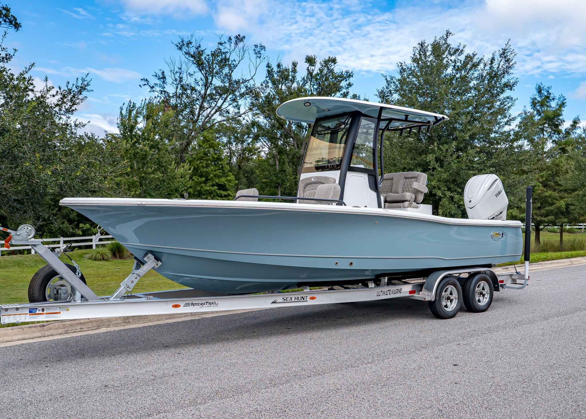 Sea Hunt BX 25 FS 2026 Sea Hunt BX 25 FS boat on trailer, parked on a road with trees in background.