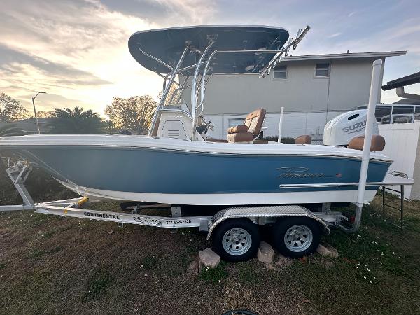 Pioneer 202 Sportfish 2024 Pioneer 202 Sportfish boat on trailer, blue hull, parked outdoors.