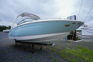 Regal LX6 2026 Regal LX6 boat displayed on gravel lot under cloudy sky.