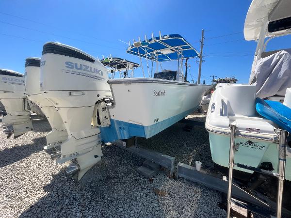 SeaCraft 32 MASTER ANGLER 2000 SeaCraft 32 Master Angler boat with Suzuki outboard engines, parked on gravel.