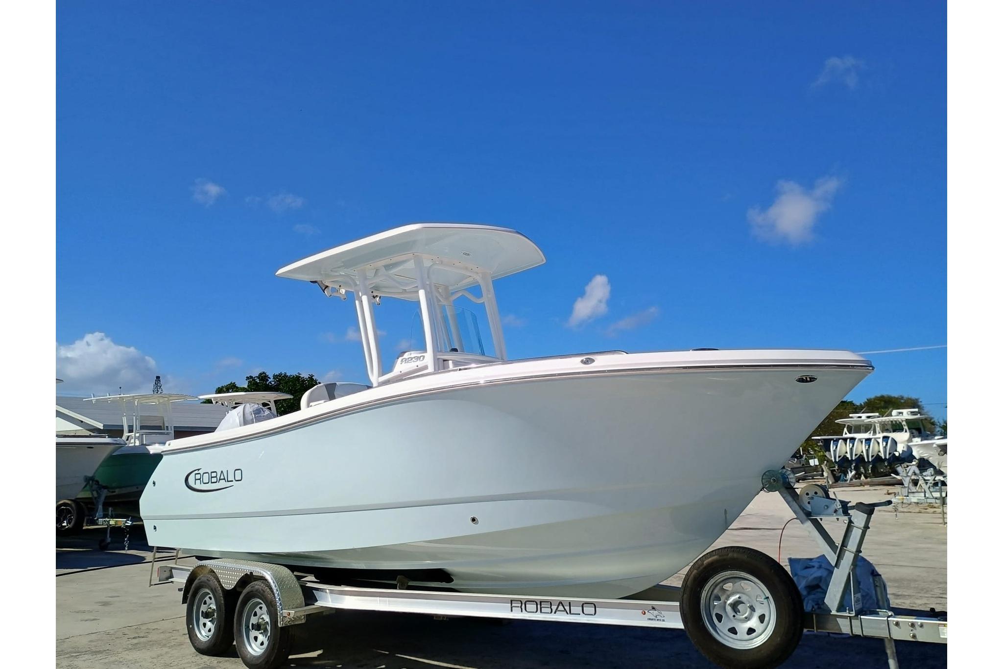 Robalo R230 Center Console 2025 Robalo R230 Center Console boat on trailer under clear blue sky.