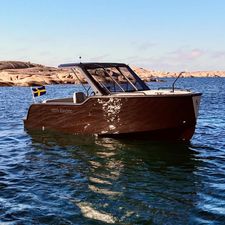 X Shore 1 2024 X Shore 1 electric boat on water, Swedish flag, sunny day.