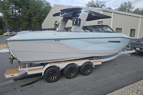 Nautique Super Air Nautique G23 2025 Nautique Super Air Nautique G23 boat on trailer, sleek design, parked outdoors.